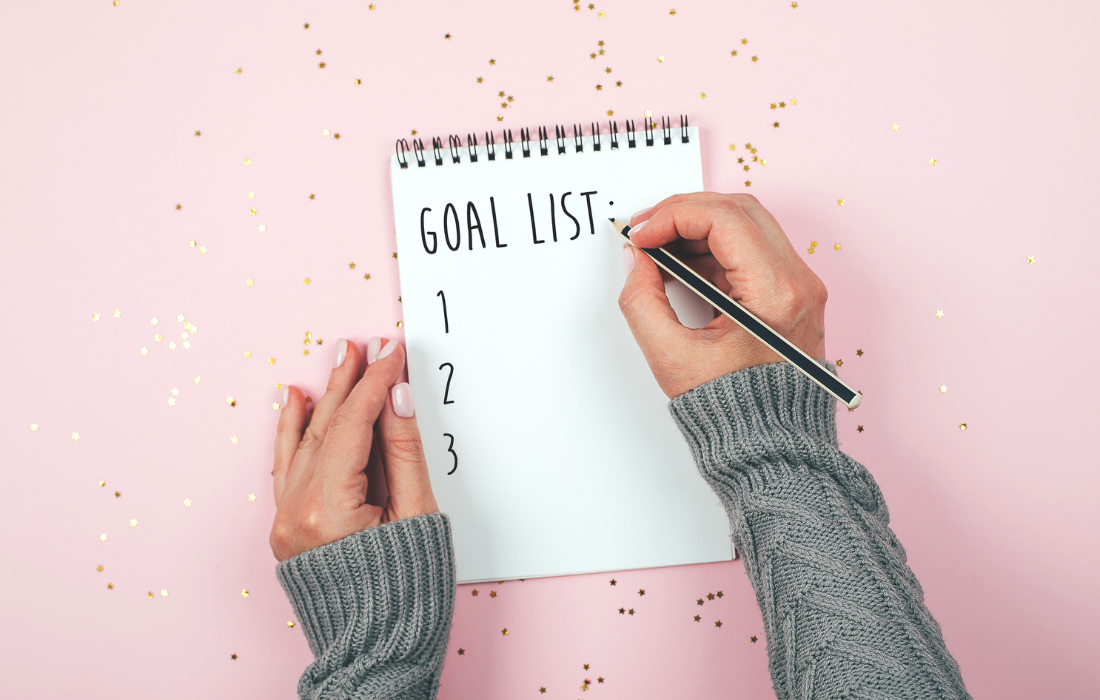 woman is writing out her intuitive eating goals